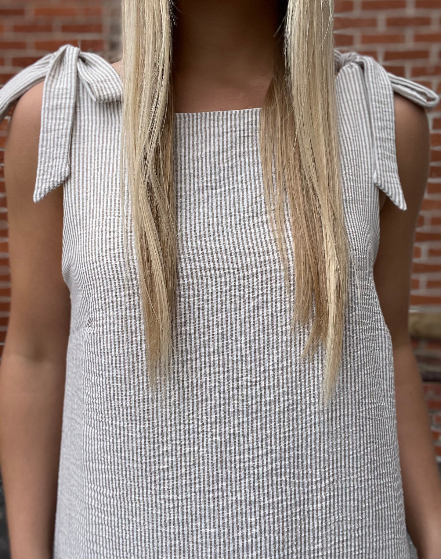 The Calla Sleeveless Shoulder Tie Mini Dress